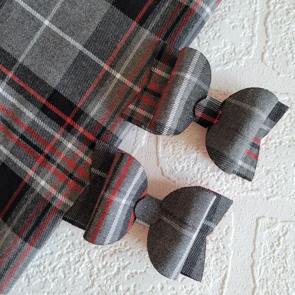 Two tartan bows with red and grey tartan fabric
