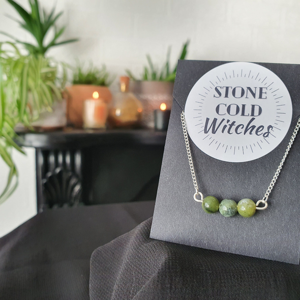 3x small green Jade crystals gathered in a line, on a horizontal silver wire  connected onto a dainty silver chain via looped ends