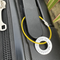 1 inch aluminium washer stamped with the words life is an adventure.  the washer has been threaded onto a yellow gold wire to make a luggage tag.  the item is shown attached to the handle of a suitcase.