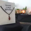 Small tigers eye polished crystal on a black chain, bound using a simple black wire wrap