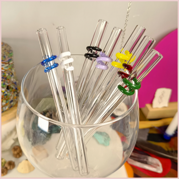 Multiple colours of straws inside a glass