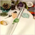 Close up of a handmade glass straw with a leaf design