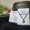 Hematite crystal cube on black chain, hung with a simple black wire loop that holds the cube diagonally