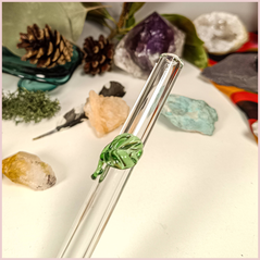 Close up of a handmade glass straw with a leaf design