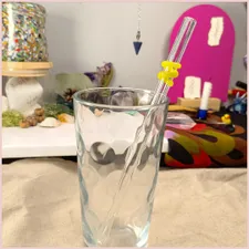 A yellow coil straw inside a glass