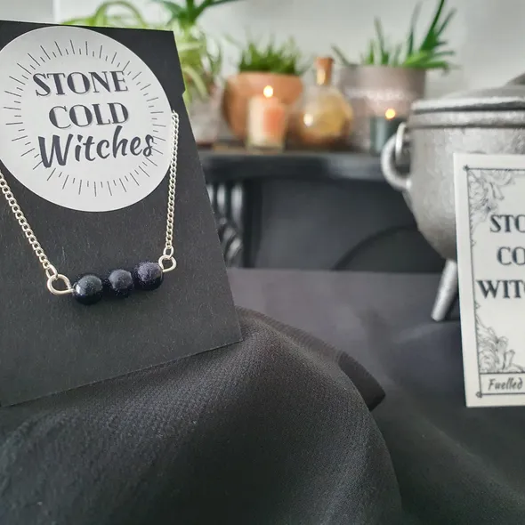 3x small blue goldstone crystals gathered in a line, on a horizontal silver wire  connected onto a dainty silver chain via looped ends