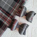 Two tartan bows with red and grey tartan fabric