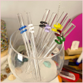 Multiple colours of straws inside a glass
