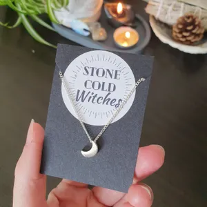 small shiny crescent moon on a dainty short choker style chain
