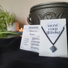 Hematite crystal cube on black chain, hung with a simple black wire loop that holds the cube diagonally