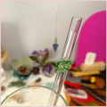 Close up of a handmade glass straw with a leaf design