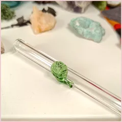 Close up of a handmade glass straw with a leaf design