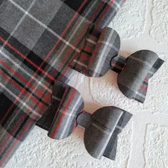 Two tartan bows with red and grey tartan fabric
