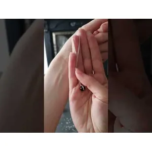 Ritual demonstration on using the protection spell kit. Video shows the user setting up 3 black candles on an altar, sprinkling salt around them and lighting each one before holding their hands next to the candles. Video then shows short timelapse of candles burning down and going out to signify end of ritual