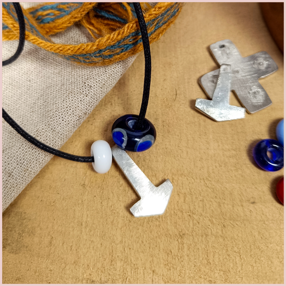 the repton bead and small white bead with a pewter mjolnir on a cord
