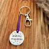 1 inch aluminium disc hand stamped with the words making memories with stars above and below.  shown on a purple cord turning the disc into a hanging keyring