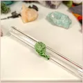 Close up of a handmade glass straw with a leaf design