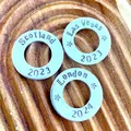 image shows 3 additional 1 inch aluminium washers which can be added to any wire luggage tag.  the washers shown are stamped with the words scotland 2023, las vegas 2023 and london 2024.  the listing is for one personalised additional washer which can be added to any wire luggage tag.