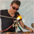 Photo of Scarlet at the flame melting glass
