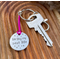 1 inch aluminium disc hand stamped with the words living my best life in lowercase font with small stars above and below.  shown on a bright pink cord to turn the disc into a hanging keyring
