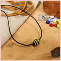 Subbersund Wasp Bead. A black bead with three raised lines of yellow shown on a cord