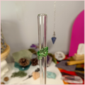 Close up of a handmade glass straw with a leaf design