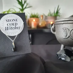 Small black obsidian polished crystal on a dainty silver chain, bound using a simple silver wire wrap