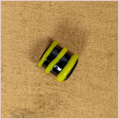Subbersund Wasp Bead. A black bead with three raised lines of yellow close up detail