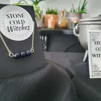 3x small blue goldstone crystals gathered in a line, on a horizontal silver wire  connected onto a dainty silver chain via looped ends