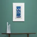 Blue White and Teal Waves Print in Framed in White on a Blue Wall Above Dark Shelf and Vase Set