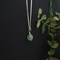 small crystal sphere of green aventurine, bound in a simple silver look wire wrap onto a dainty silver plated chain