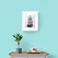 Blue Yellow and Silver Pebbles Stack Print in Framed in White on a Blue Wall Above a Wooden Drawer Unit