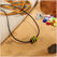Subbersund Wasp Bead. A black bead with three raised lines of yellow shown on a cord