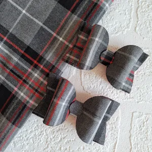 Two tartan bows with red and grey tartan fabric