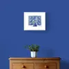 Peacock with Splayed Feathers in Green and Blue Framed in White on a Blue Wall Above a Wooden Drawer Unit